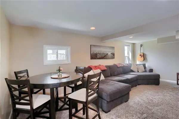a living room with furniture a rug and a table