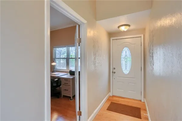 a view of a hallway and a livingroom with wooden floor