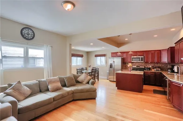 a living room with furniture kitchen and a window