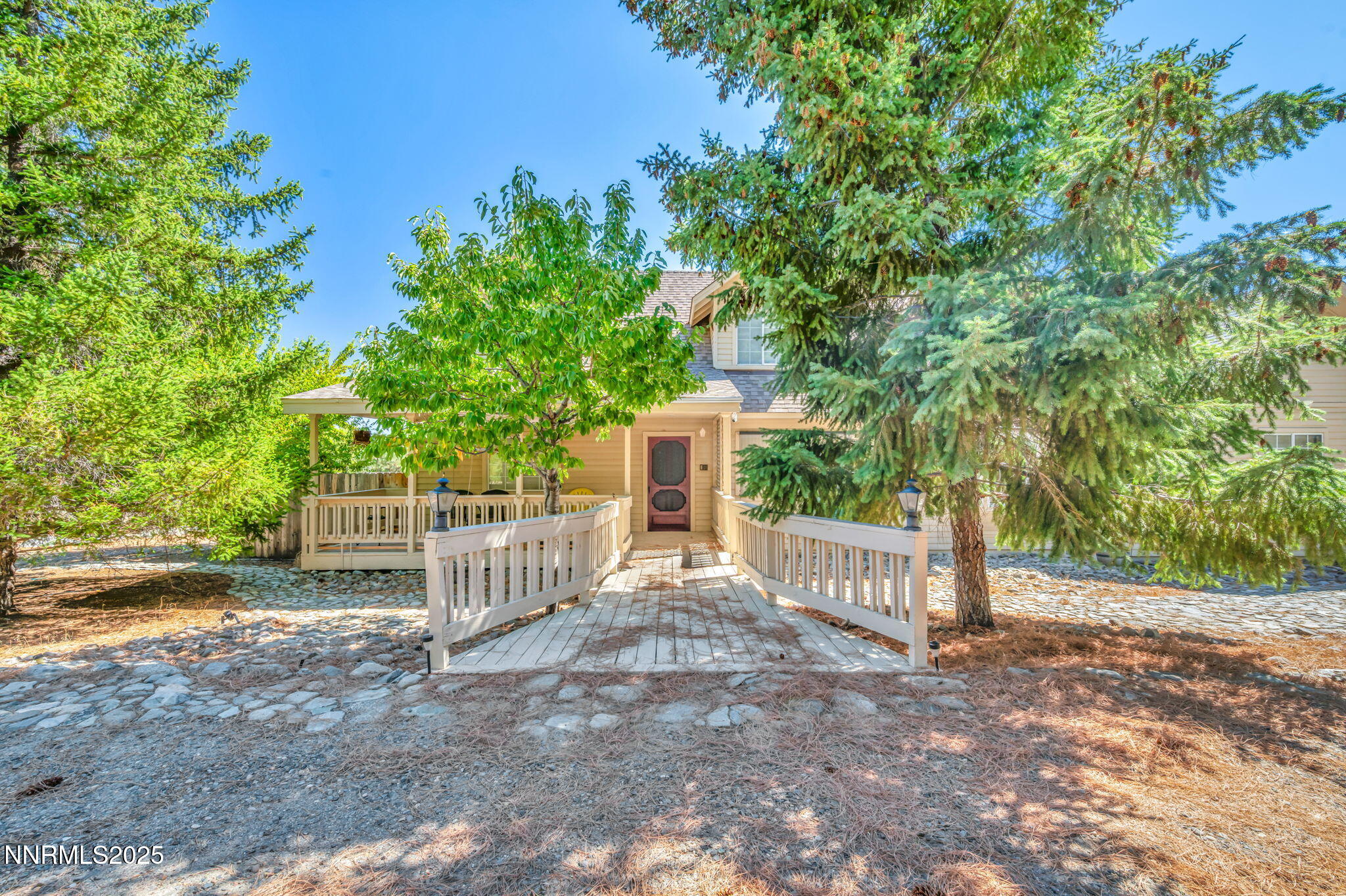 2395 Jacks Valley Road Genoa, NV 89411 - Photo 1 of 33 a view of a house with a large tree and wooden fence