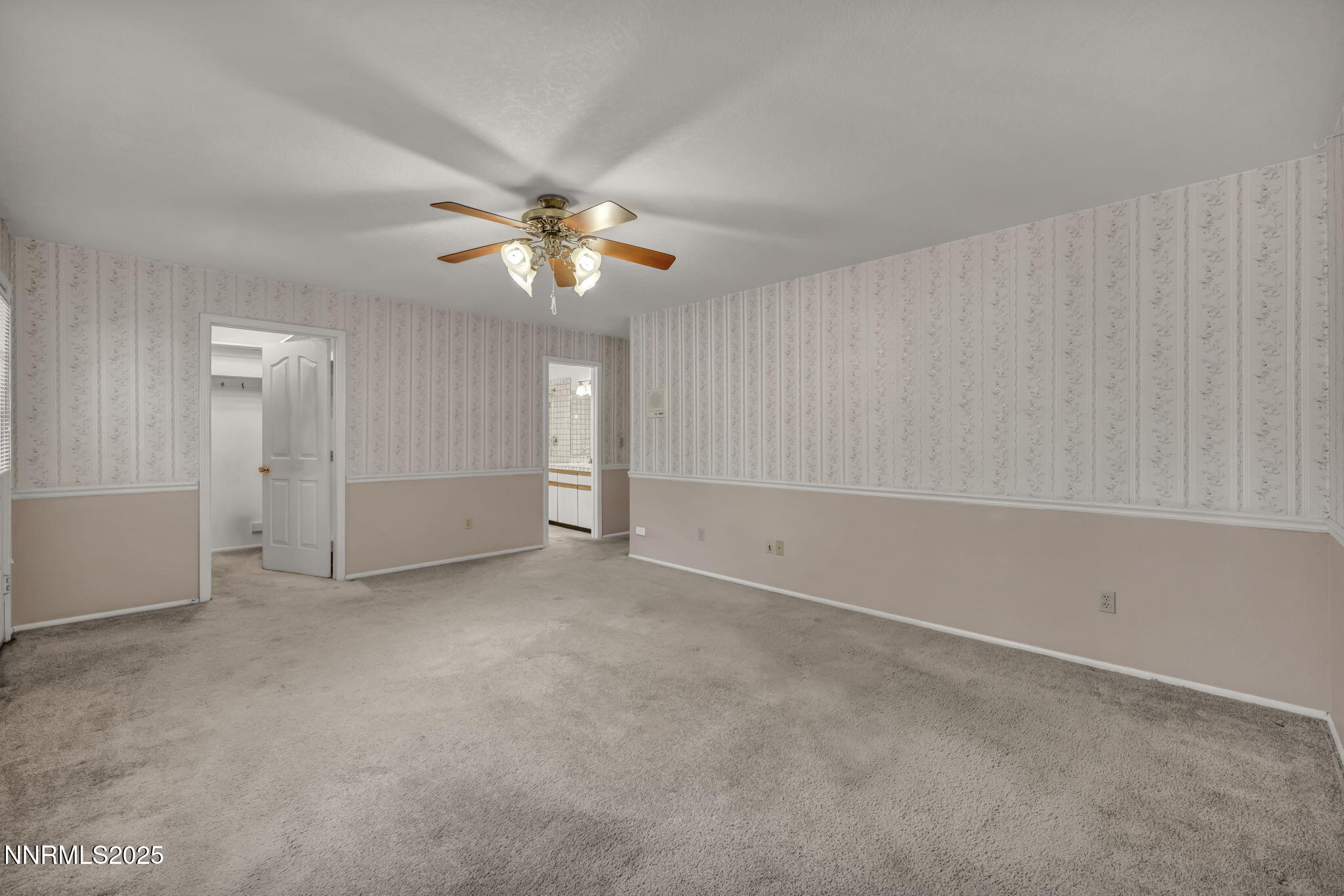 2395 Jacks Valley Road Genoa, NV 89411 - Photo 11 of 33 an empty room with chandelier fan and windows
