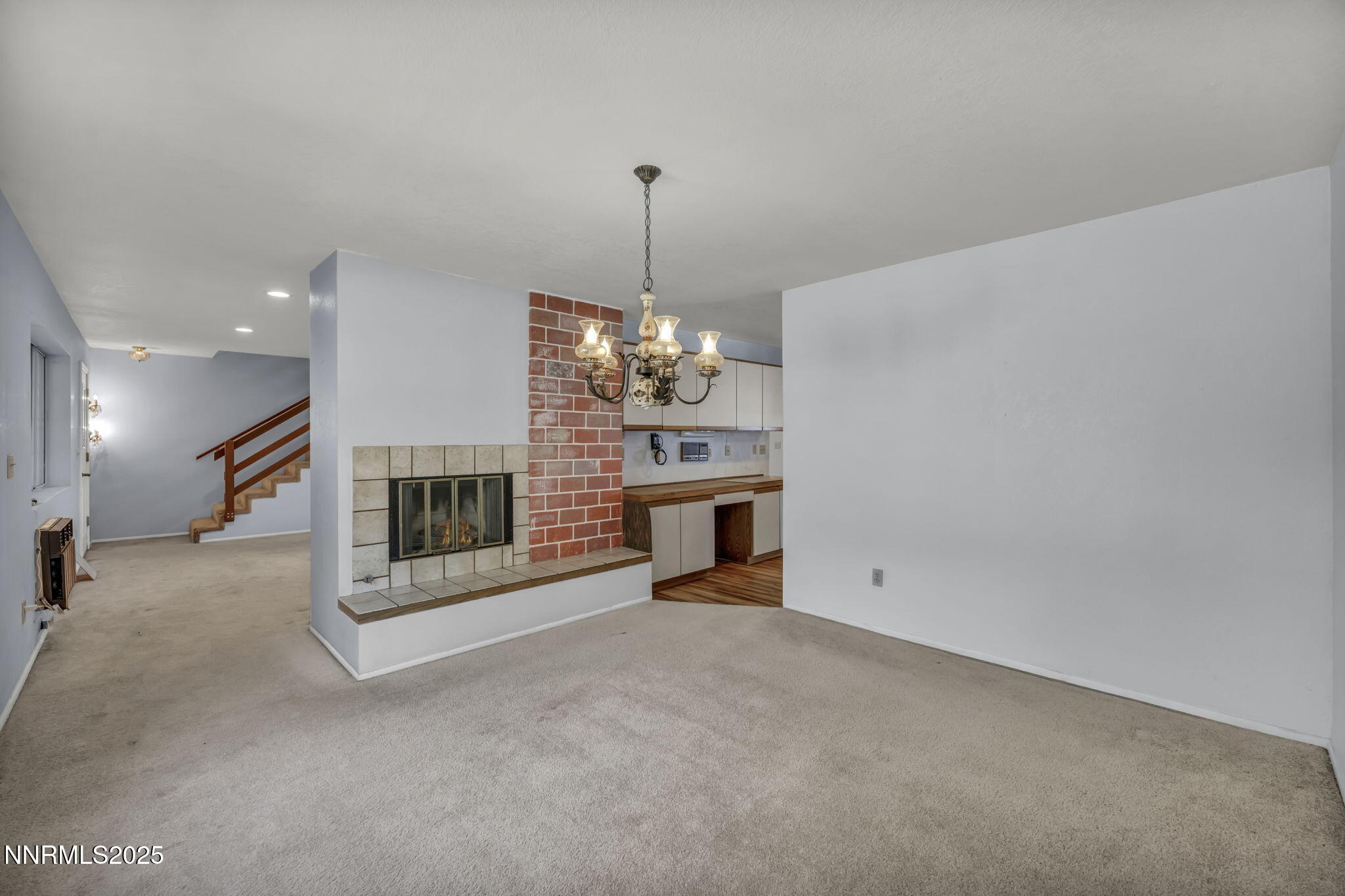 2395 Jacks Valley Road Genoa, NV 89411 - Photo 2 of 33 a view of a livingroom with a fireplace a chandelier and windows