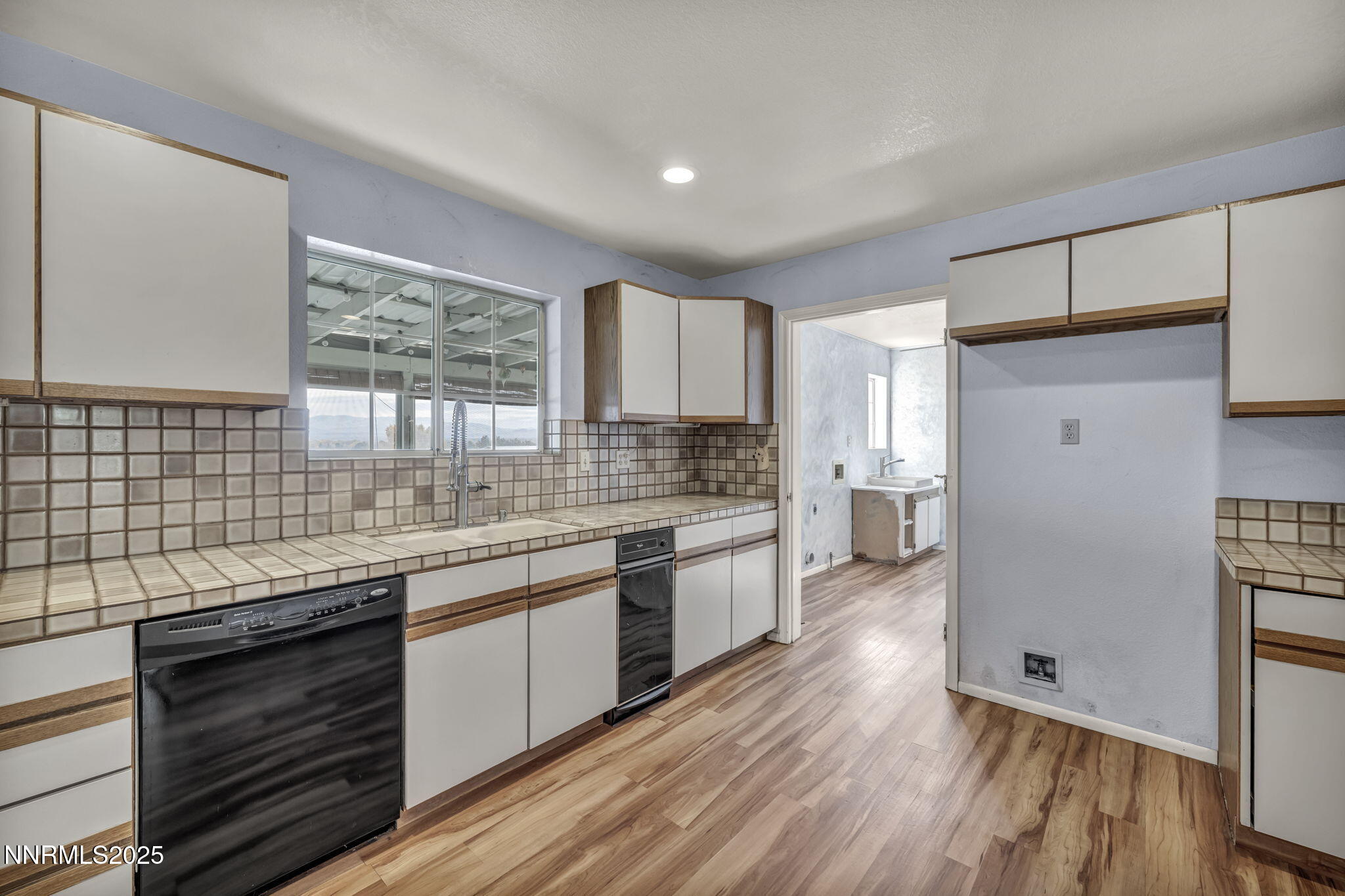 2395 Jacks Valley Road Genoa, NV 89411 - Photo 4 of 33 a kitchen with granite countertop wooden floors and white stainless steel appliances
