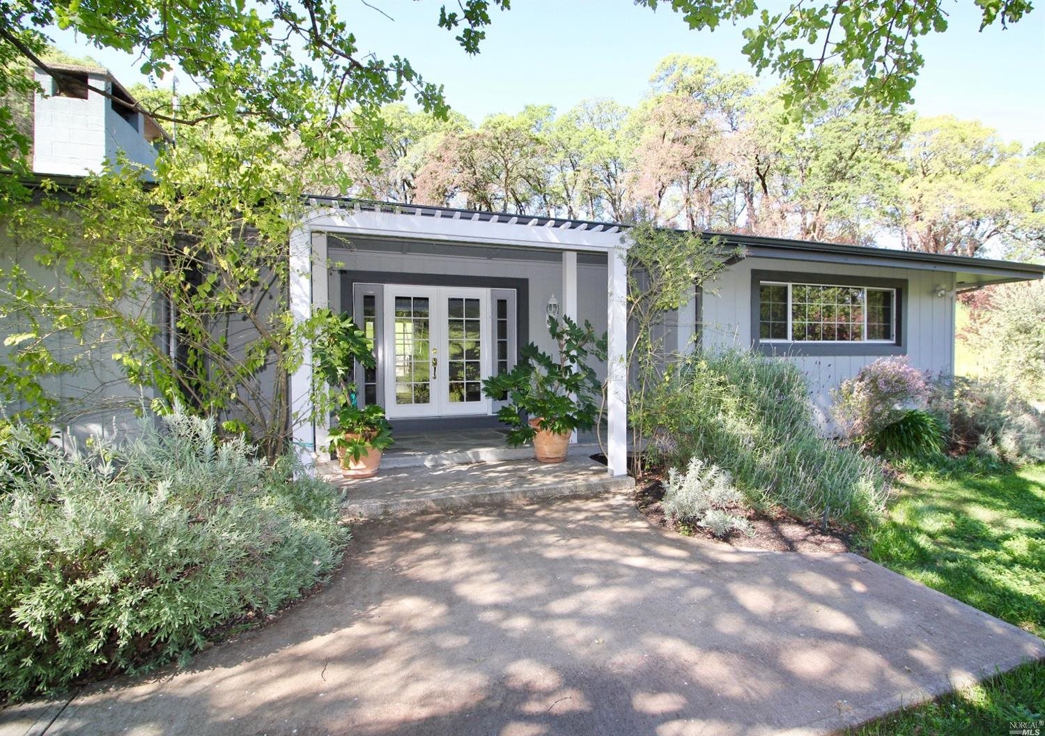 3275 Wooden Valley Road Napa, CA 94558 - Photo 1 of 1 a view of a house with brick walls and potted plants