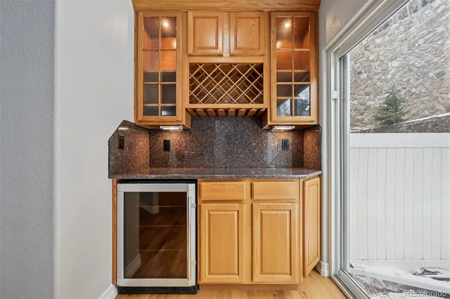 a kitchen with stainless steel appliances granite countertop a stove top oven a refrigerator a sink and dishwasher with wooden floor