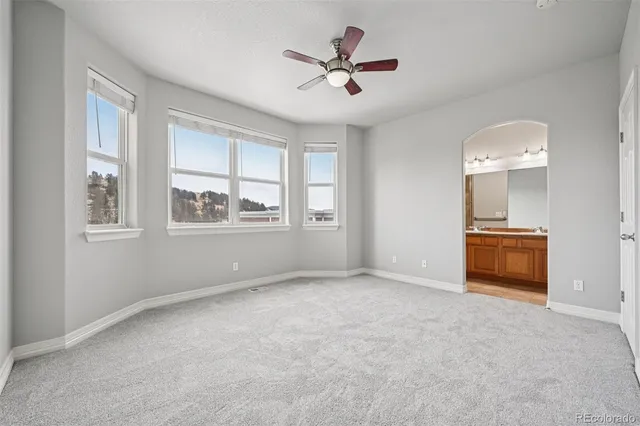 a bathroom with a granite countertop sink a mirror and a bathtub