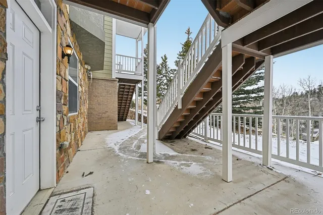 a view of a balcony with wooden floor and fence