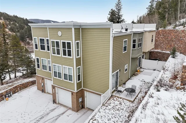 a view of a house with backyard and sitting area