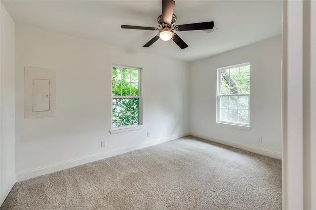 a view of room with a ceiling fan and window