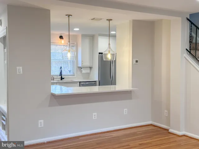 a view of a kitchen with a sink and a window