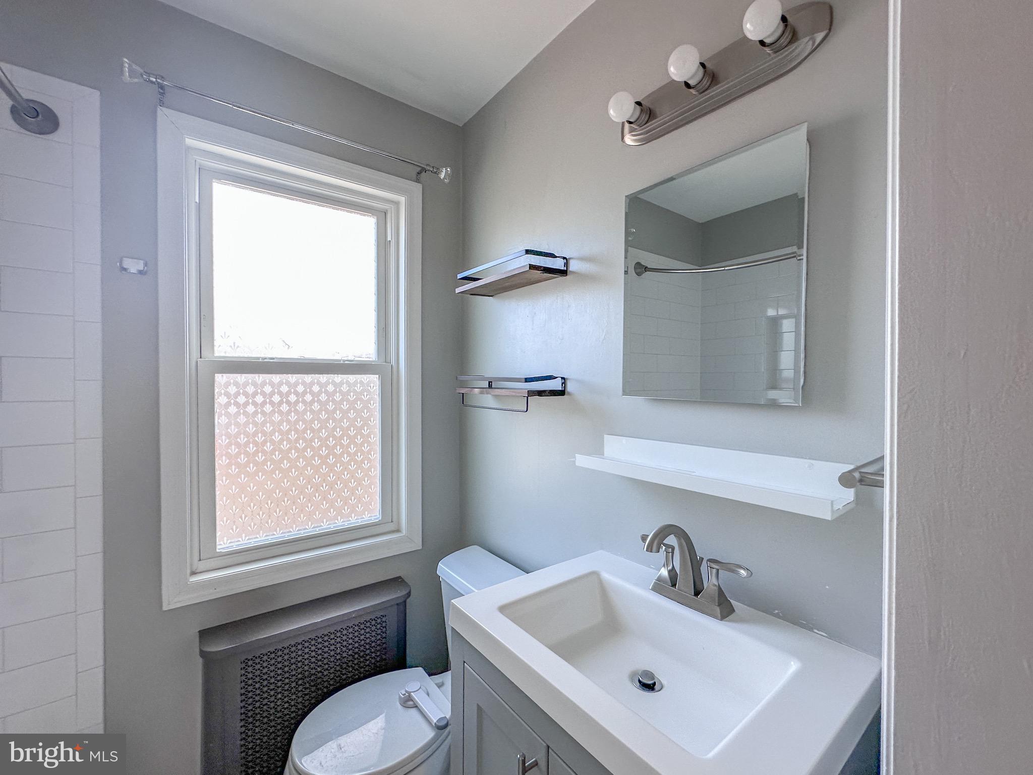 226 Guthrie Avenue Alexandria, VA 22305 - Photo 20 of 54 a bathroom with a sink mirror and toilet