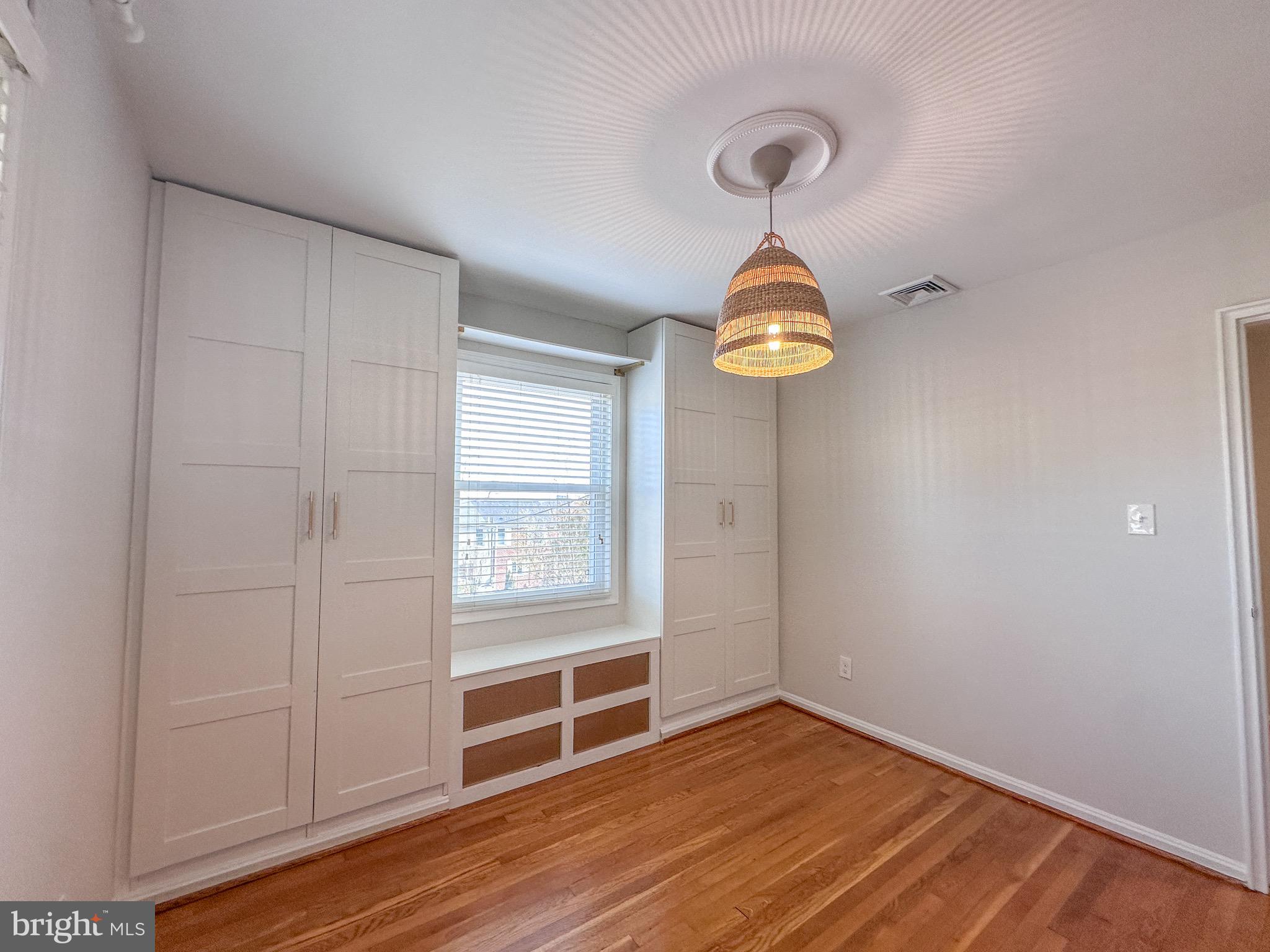 226 Guthrie Avenue Alexandria, VA 22305 - Photo 24 of 54 wooden floor in an empty room with a window
