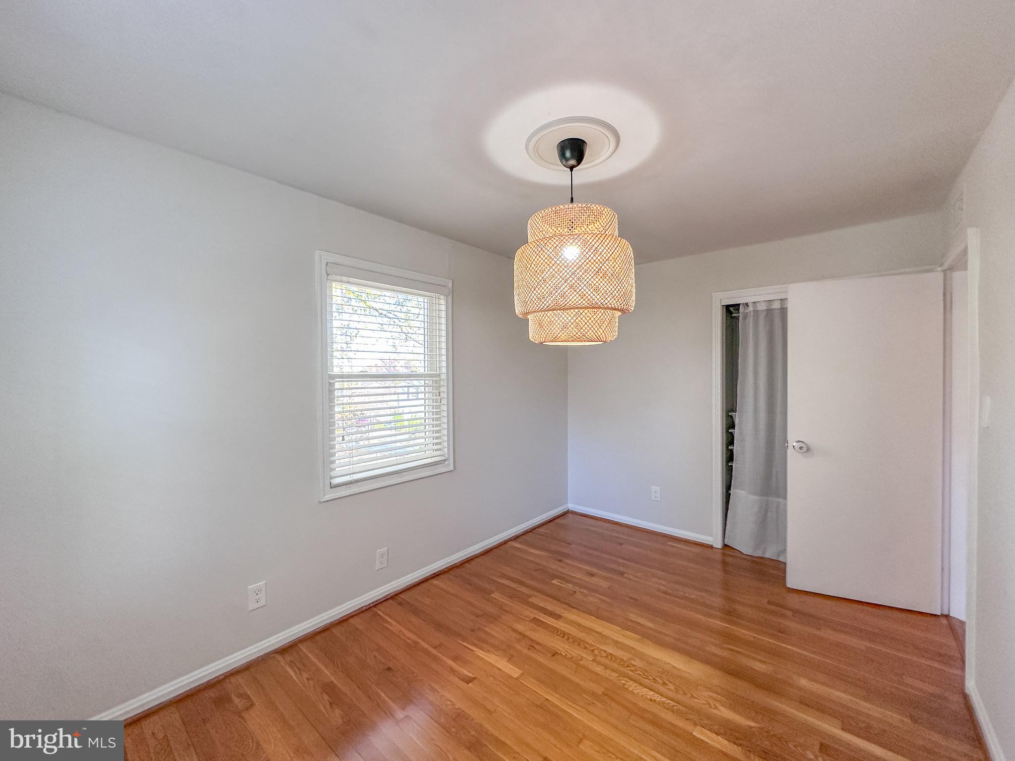 226 Guthrie Avenue Alexandria, VA 22305 - Photo 27 of 54 a view of an empty room with wooden floor and a window
