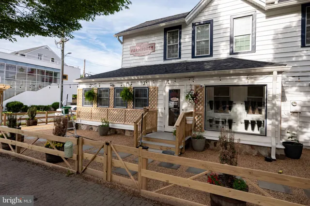 a view of a shop with a brick wall and a barbeque
