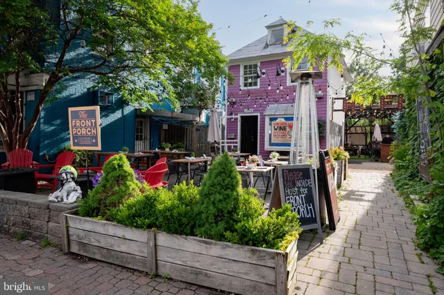 a front view of a house with a yard and potted plants
