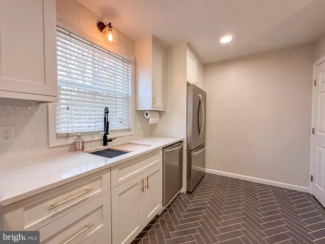 a view of a kitchen from a hallway