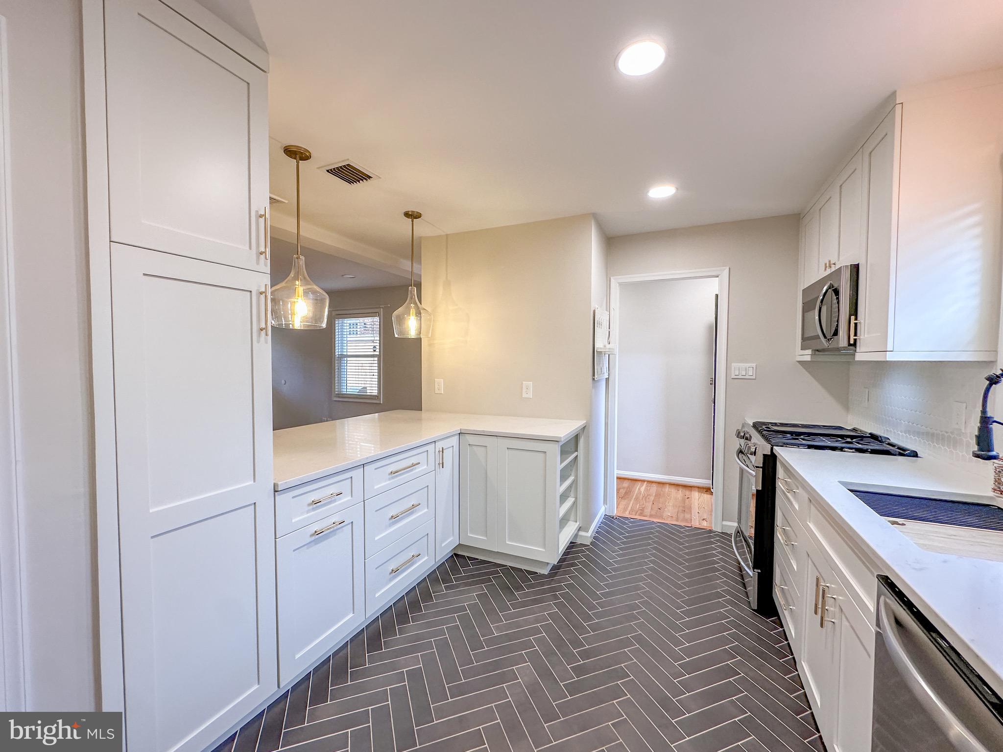 226 Guthrie Avenue Alexandria, VA 22305 - Photo 7 of 54 a kitchen with granite countertop white cabinets and white appliances
