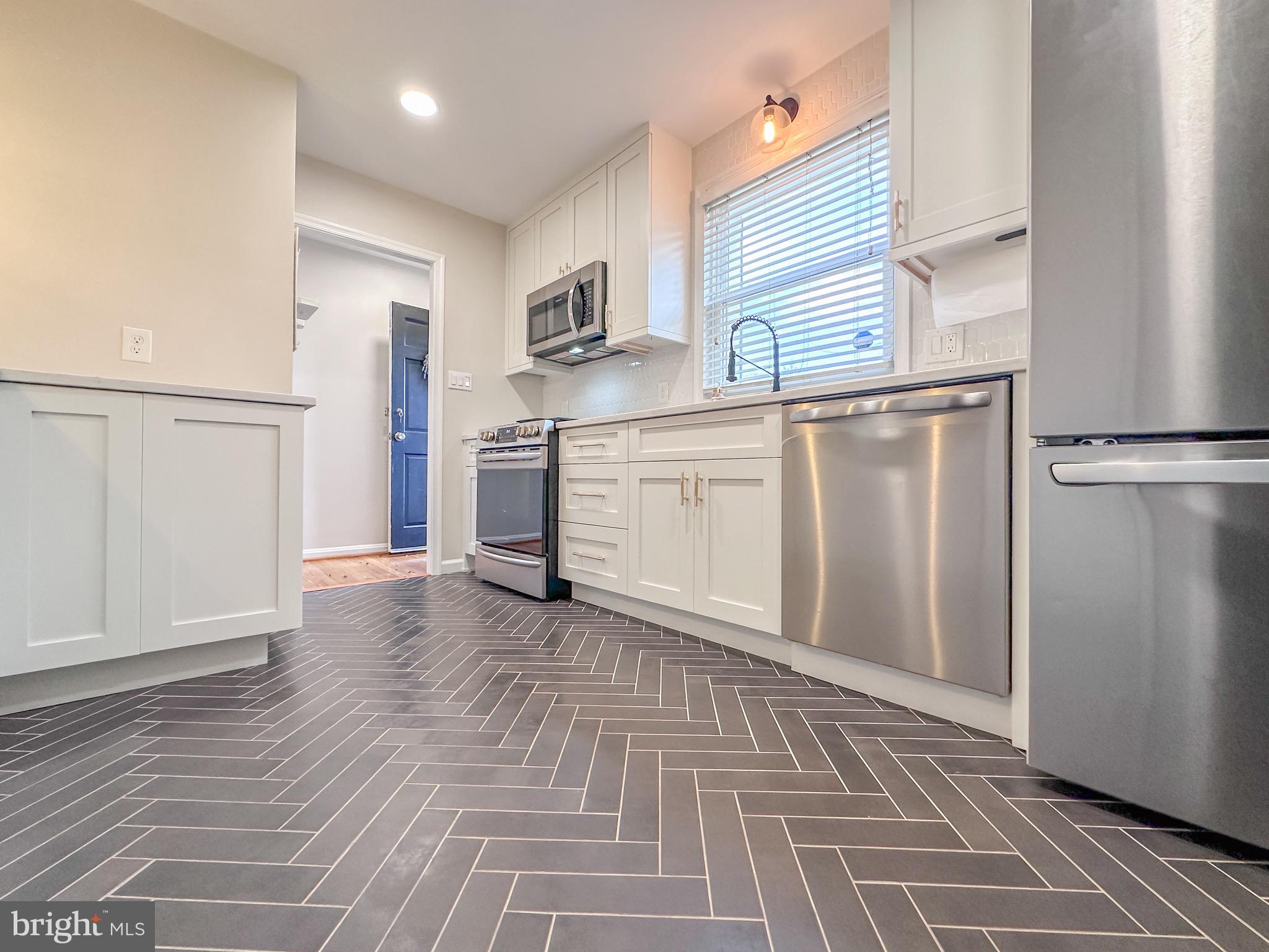 226 Guthrie Avenue Alexandria, VA 22305 - Photo 10 of 54 a kitchen with stainless steel appliances granite countertop a refrigerator and a stove