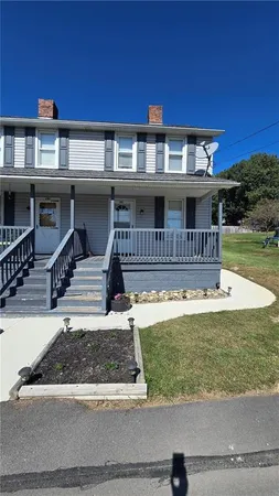 a front view of a house with a yard