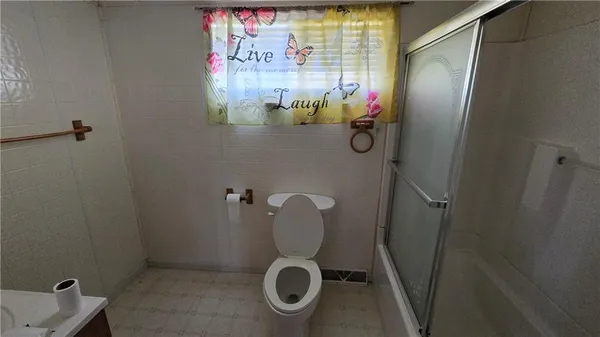 a bathroom with a shower and toilet