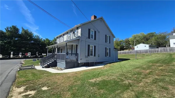 a front view of a house with a garden