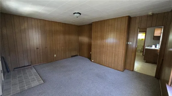 a view of an empty room with wooden door