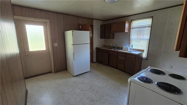 a kitchen with a refrigerator stove and sink