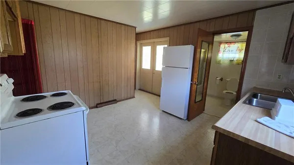 a kitchen with a refrigerator and a sink