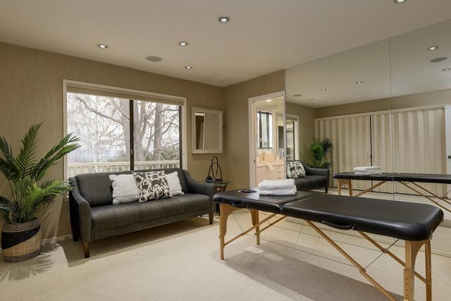 a bedroom with a bed and large window