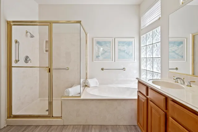a bathroom with a tub sink and mirror