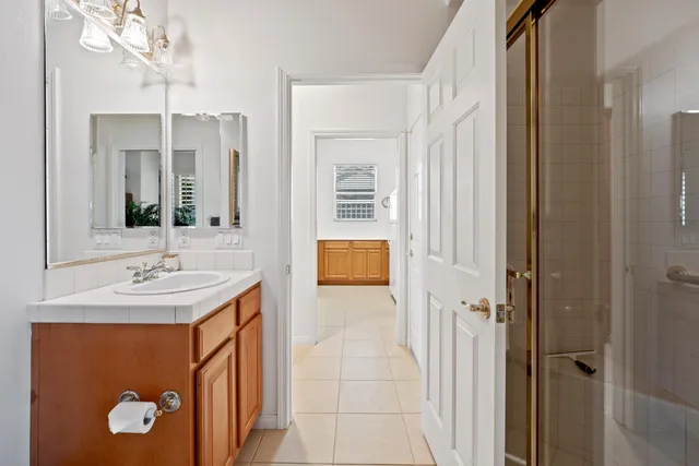 a bathroom with a sink a mirror and a shower