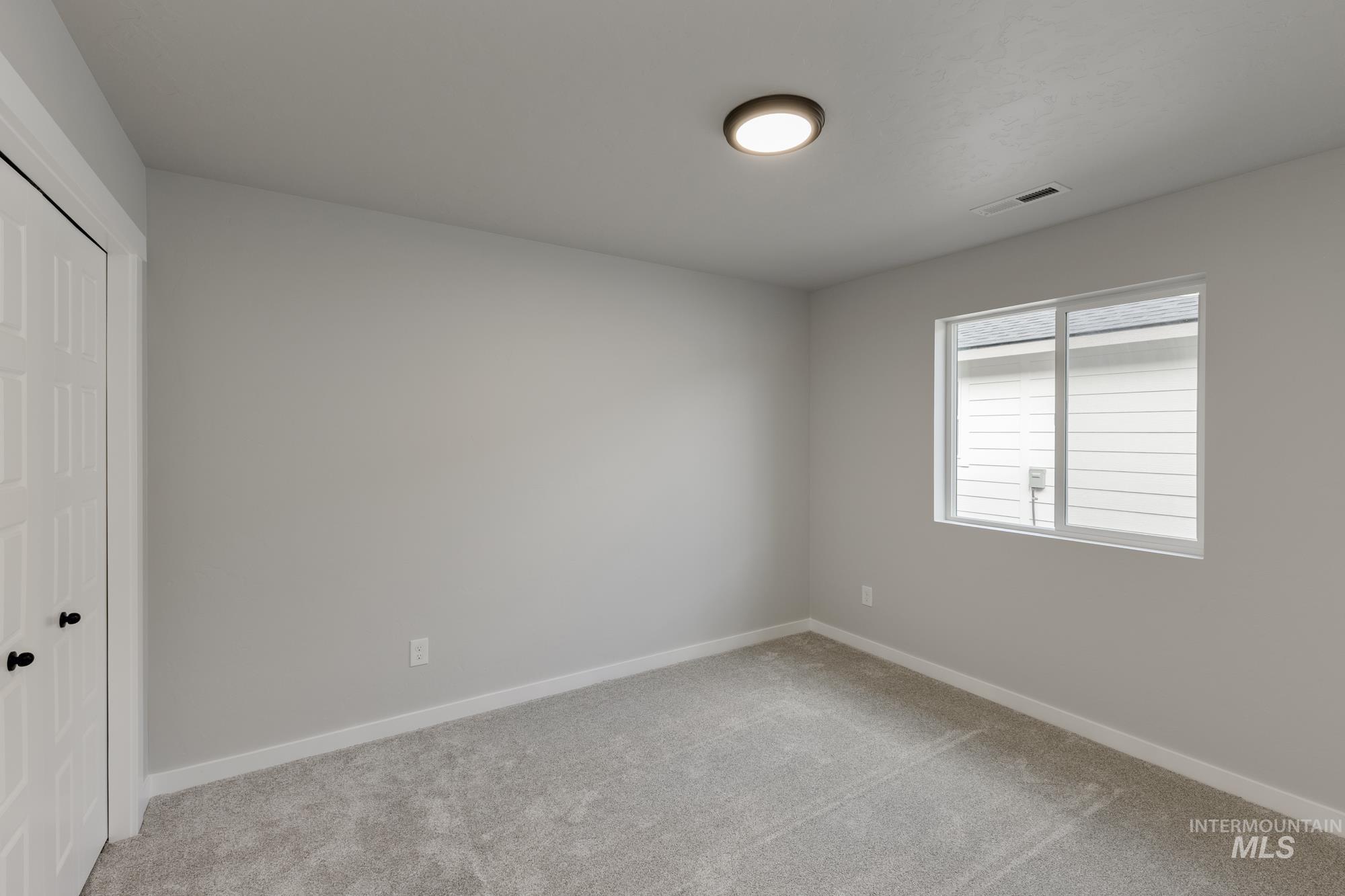 931 North Aleppo Way Meridian, ID 83642 - Photo 11 of 20 Unfurnished bedroom featuring a closet and light colored carpet