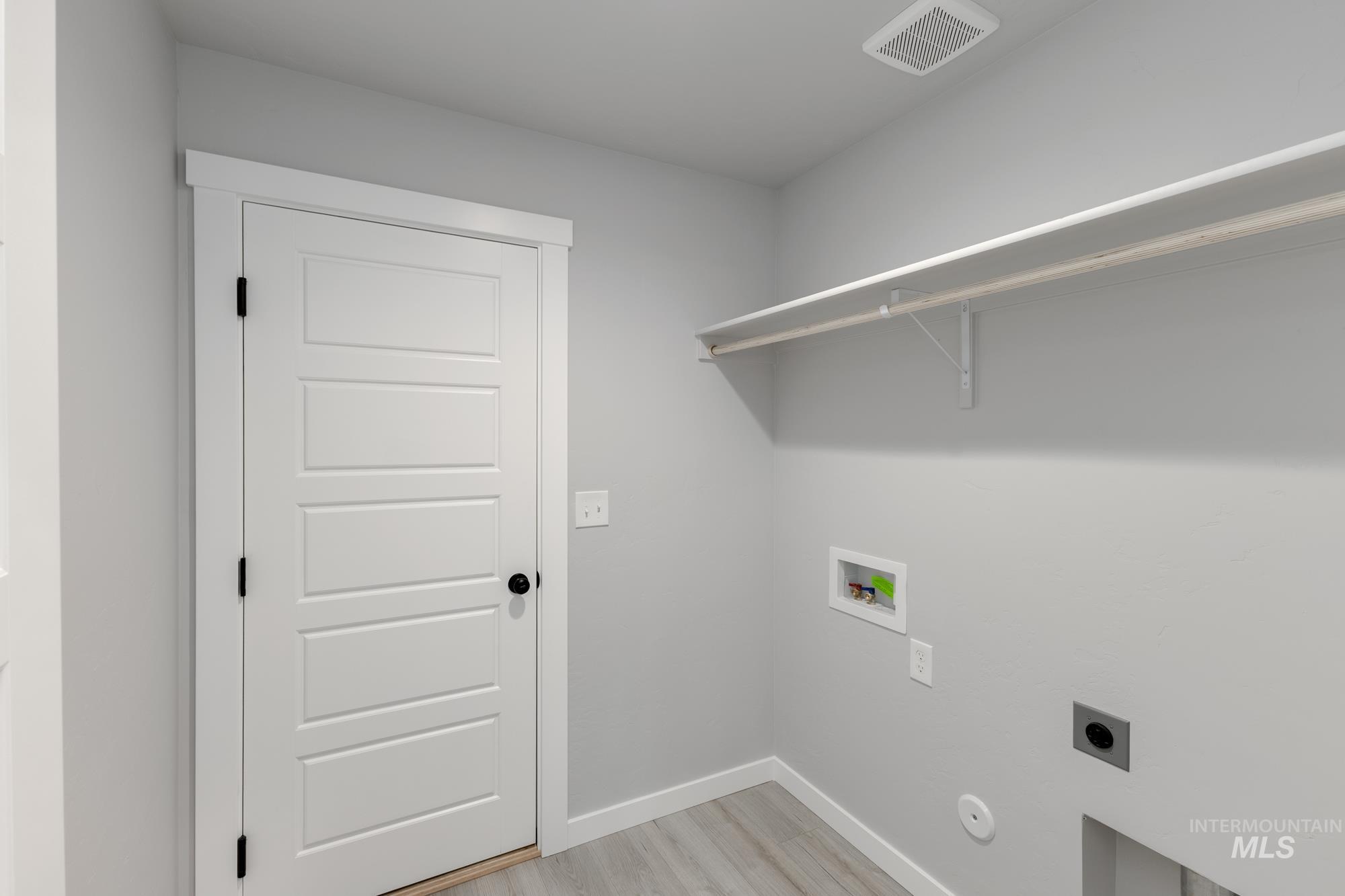 931 North Aleppo Way Meridian, ID 83642 - Photo 12 of 20 Laundry area with light wood finished floors, hookup for a washing machine, and hookup for an electric dryer