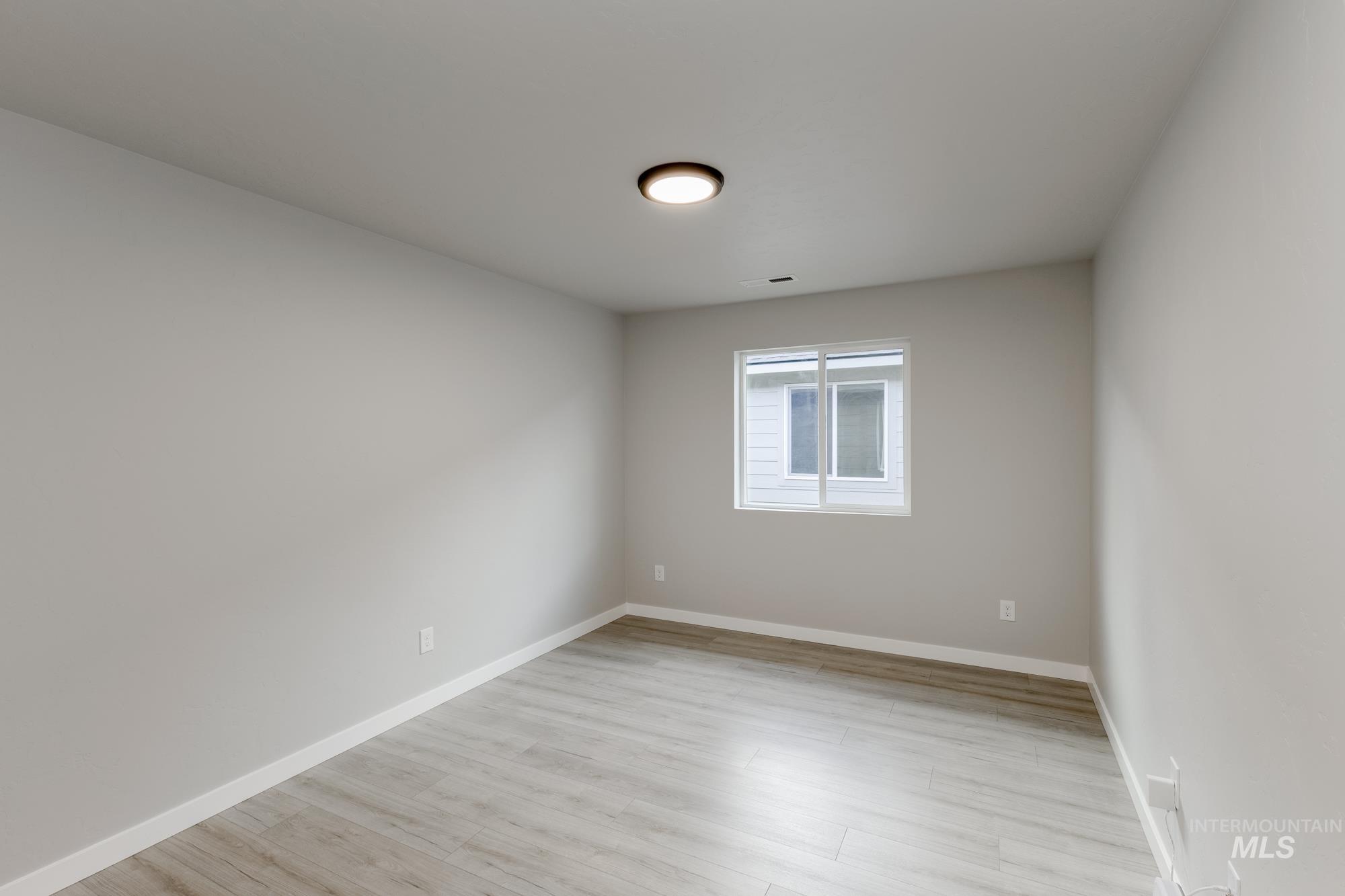 931 North Aleppo Way Meridian, ID 83642 - Photo 13 of 20 Spare room featuring light wood finished floors and baseboards