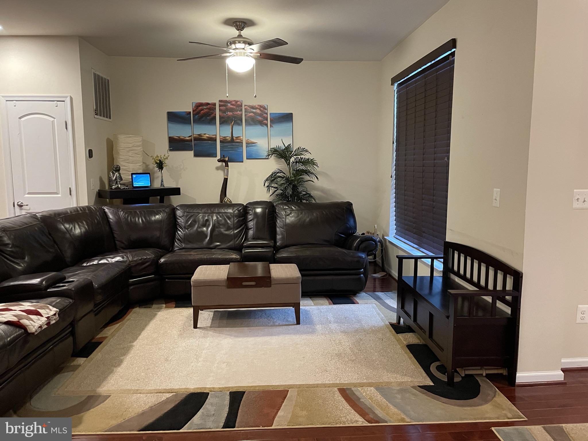 25271 Sackwheat Square Chantilly, VA 20152 - Photo 16 of 24 a living room with furniture a rug and a chandelier