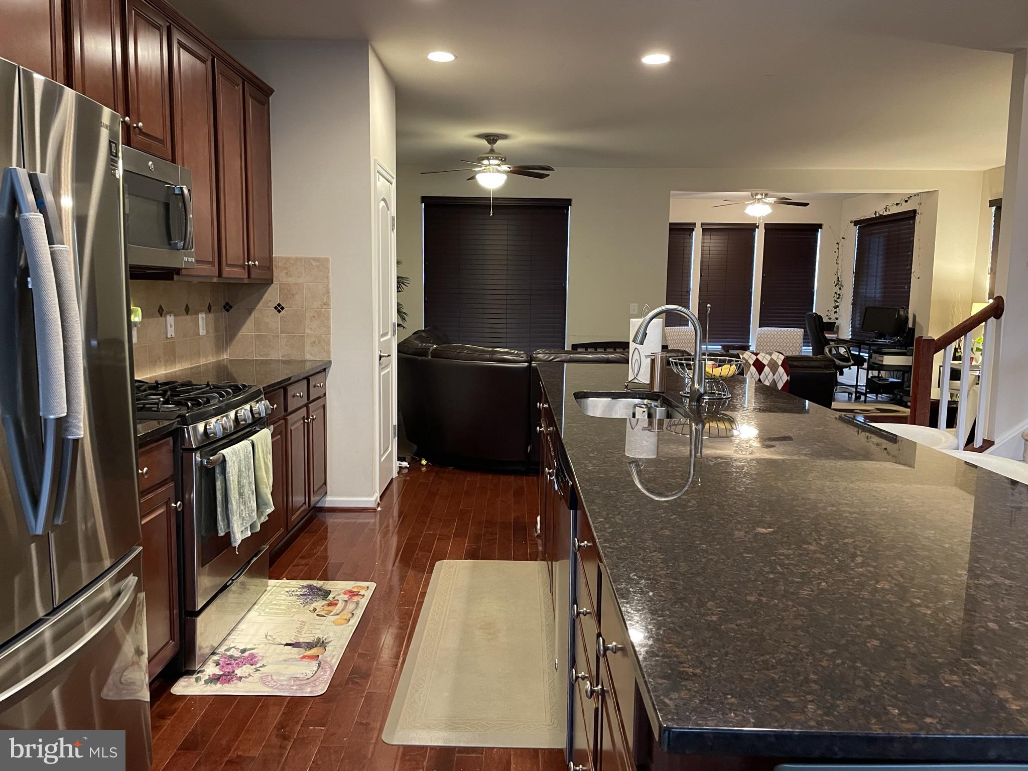 25271 Sackwheat Square Chantilly, VA 20152 - Photo 20 of 24 a kitchen with stainless steel appliances granite countertop a sink a stove and a refrigerator