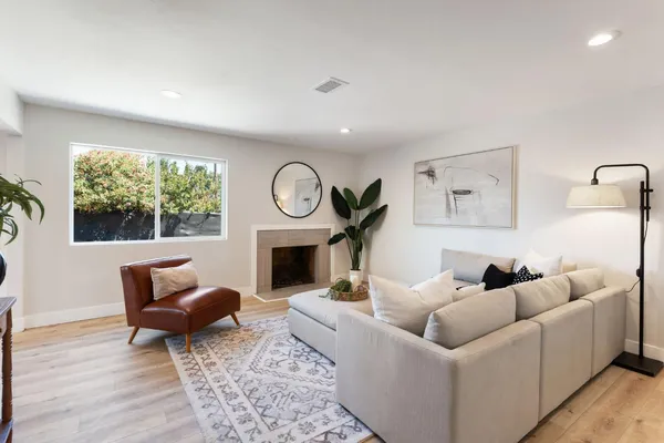 a living room with furniture a window and a fireplace