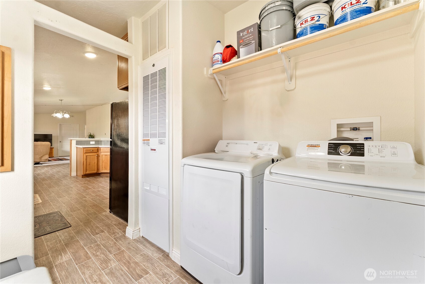 2431 Highway 153 Twisp, WA 98856 - Photo 12 of 40 a view of washer and dryer with kitchen in the background