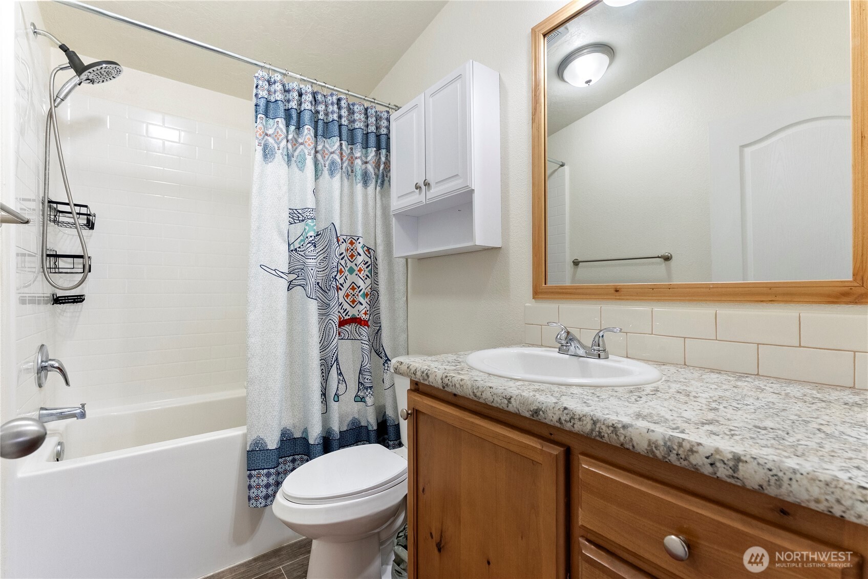 2431 Highway 153 Twisp, WA 98856 - Photo 29 of 40 a bathroom with a granite countertop sink toilet and shower