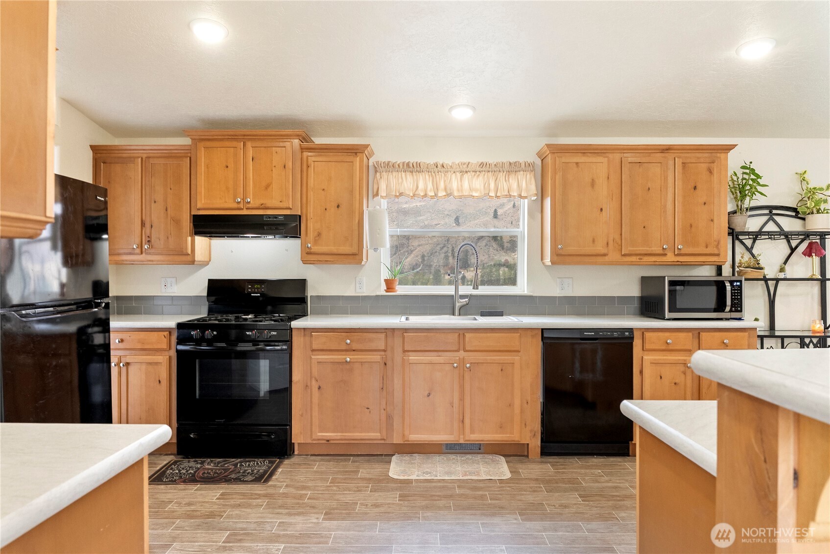 2431 Highway 153 Twisp, WA 98856 - Photo 8 of 40 a kitchen with stainless steel appliances granite countertop a stove a sink dishwasher and a refrigerator