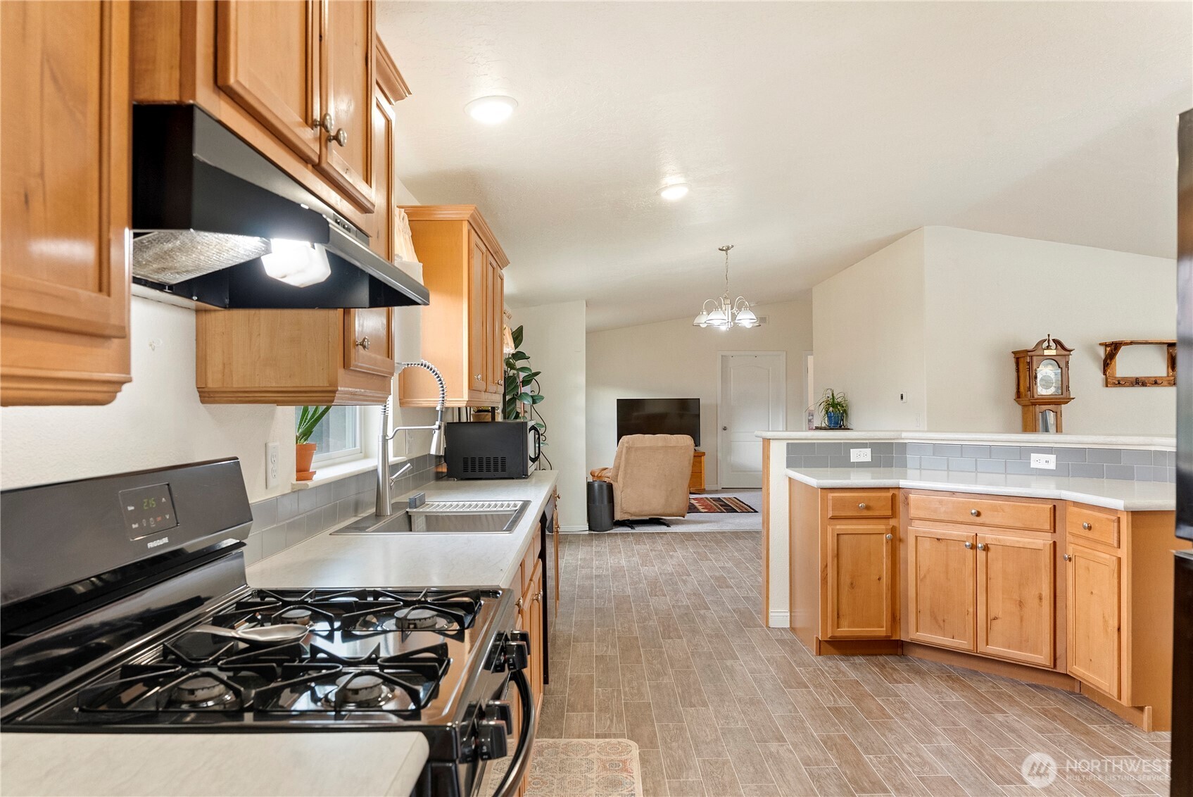 2431 Highway 153 Twisp, WA 98856 - Photo 9 of 40 a kitchen with a stove a sink and a refrigerator