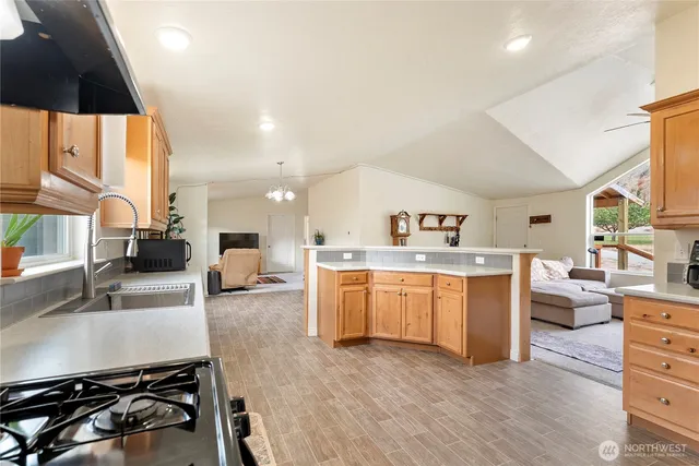 a kitchen with sink a stove and cabinets