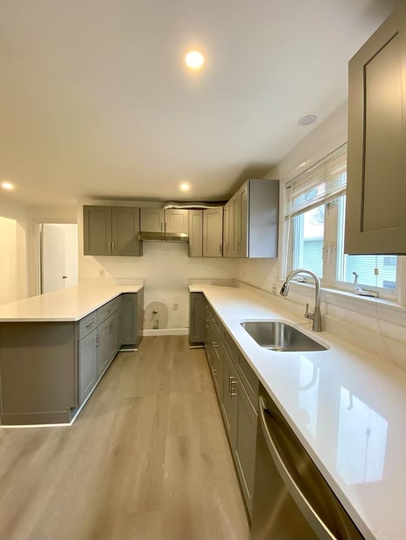 18 Howard Street, Unit 1 Waltham, MA 02451 - Photo 1 of 12 a large white kitchen with a sink and cabinets