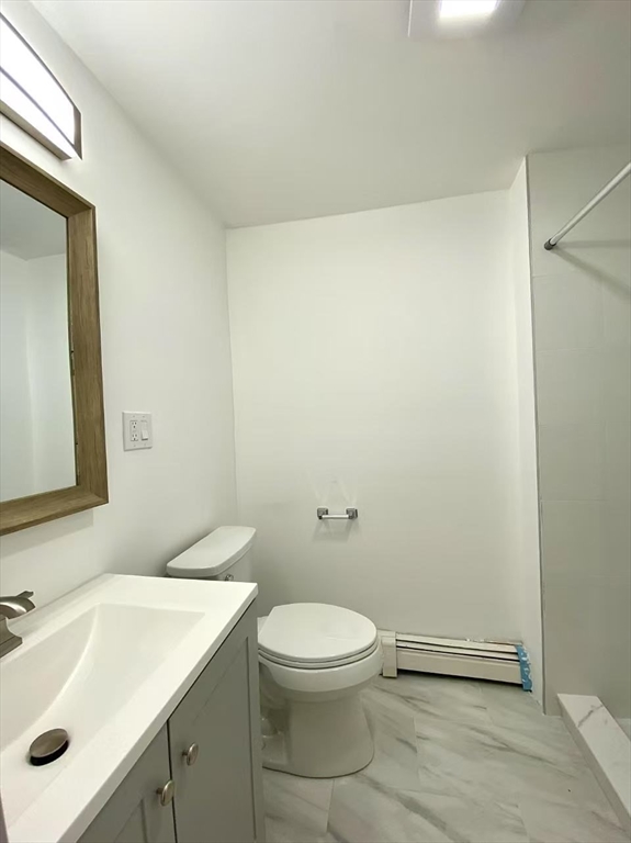 18 Howard Street, Unit 1 Waltham, MA 02451 - Photo 11 of 12 a bathroom with a sink a toilet and mirror