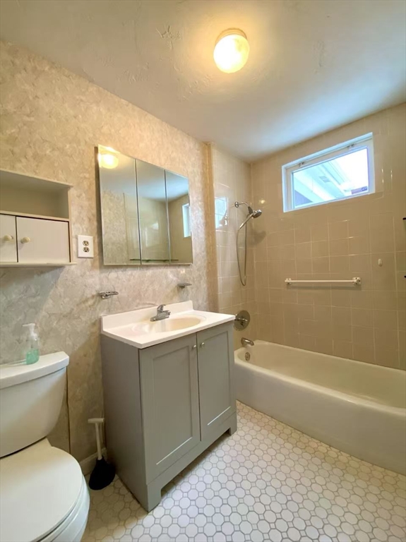 18 Howard Street, Unit 1 Waltham, MA 02451 - Photo 10 of 12 a bathroom with a sink a toilet and shower