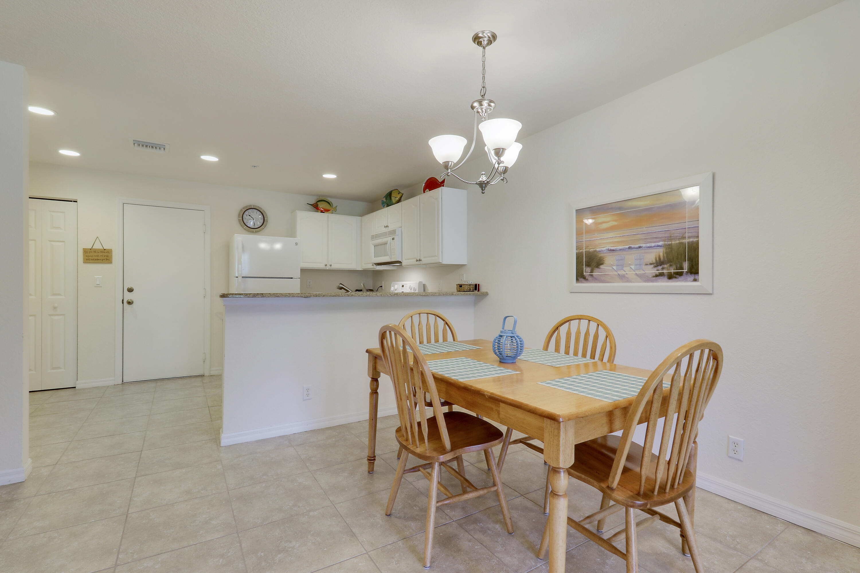 5410 Southeast Mitchell Lane Stuart, FL 34997 - Photo 10 of 24 a view of a dining room and a kitchen with a dining table chairs