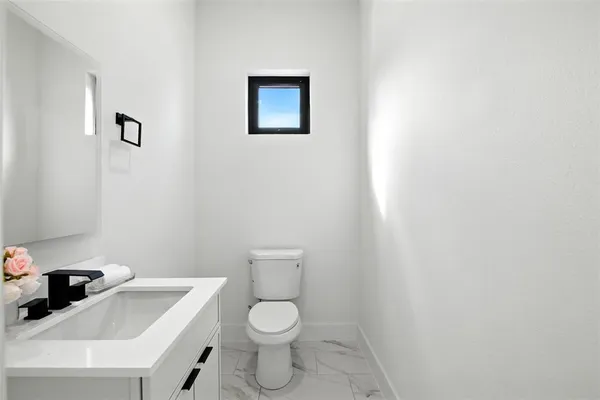 a white toilet sitting next to a white sink