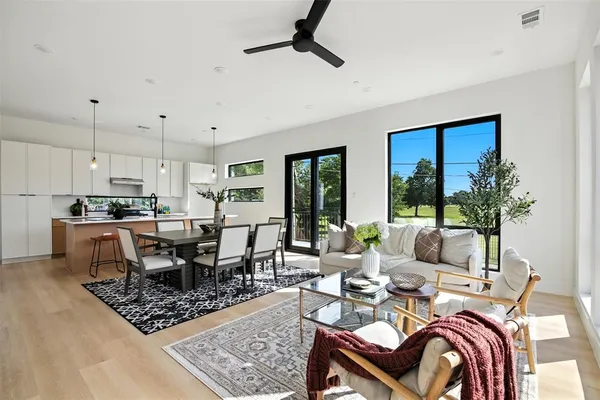 a living room with lots of furniture and kitchen view
