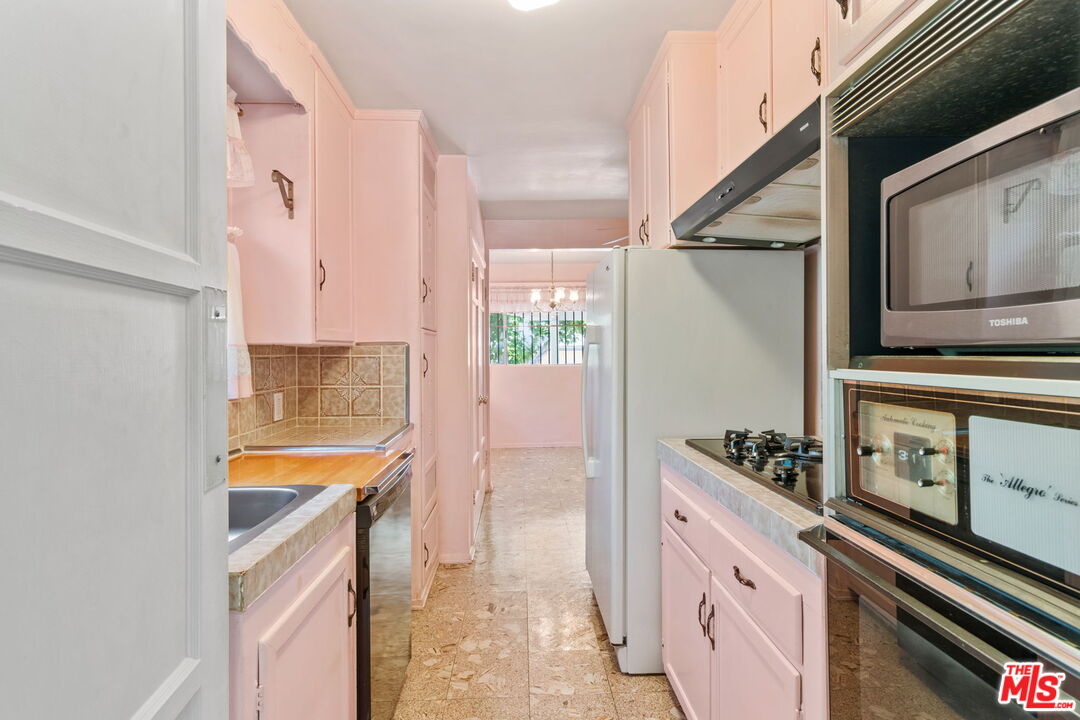6900 Corbin Avenue Reseda, CA 91335 - Photo 12 of 35 a kitchen with stainless steel appliances a stove and a refrigerator