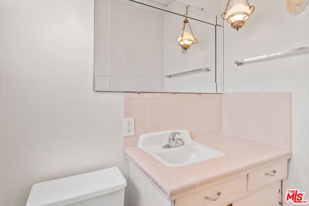 6900 Corbin Avenue Reseda, CA 91335 - Photo 19 of 35 a bathroom with a sink a toilet and mirror